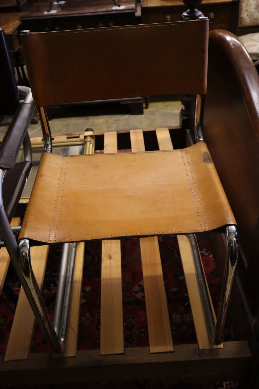 Three mid century design tubular metal and leather cantilever chairs